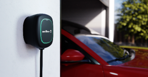 Wallbox Header image Wallbox Charging station attached to garage wall with vehicle in the background