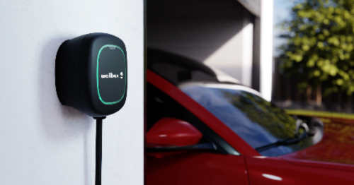 Wallbox charger attached to garage wall next to vehicle