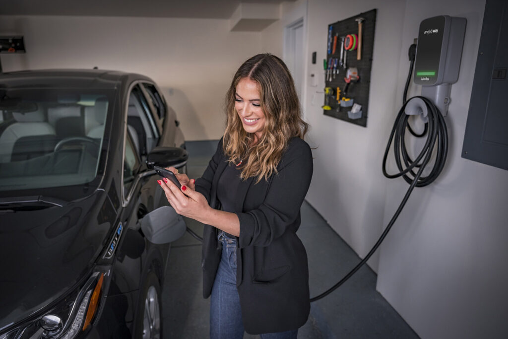 Driver charging their Chevy Bolt in their garage.